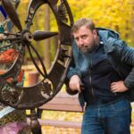 Portret dojrzałego mężczyzny stojącego przy metalowej konstrukcji